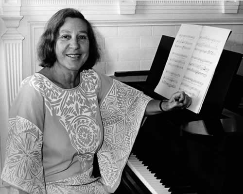 Vivian Fine seated at a piano